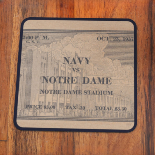Vintage 1937 college football ticket stub with Row 1 trademark in lower right corner of wood ticket coaster for Navy vs. Notre Dame game at Notre Dame Stadium on a wooden surface