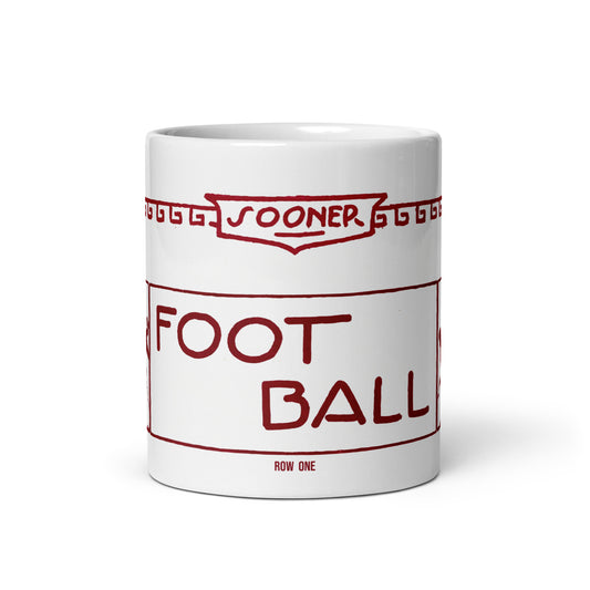 A white ceramic mug featuring a red graphic print styled like a vintage football ticket with the text 'SOONER FOOTBALL' and 'ROW ONE'.