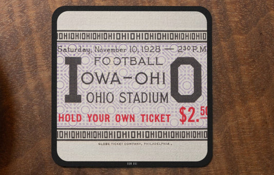 1928 Iowa Hawkeyes vs. Ohio State Football ticket coaster on a wooden surface.