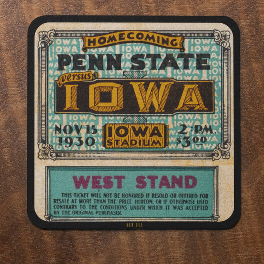 Vintage-style ticket for Penn State versus Iowa homecoming game on a wooden surface