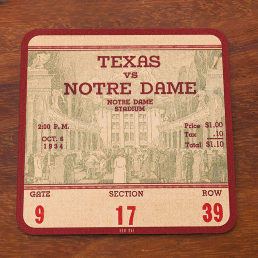 Vintage-style ticket for Texas vs Notre Dame game at Notre Dame Stadium on a wooden surface