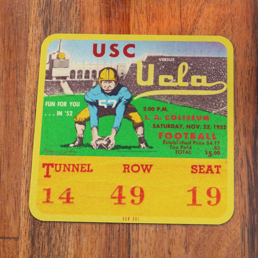 Vintage USC vs UCLA football ticket stub on a wooden surface