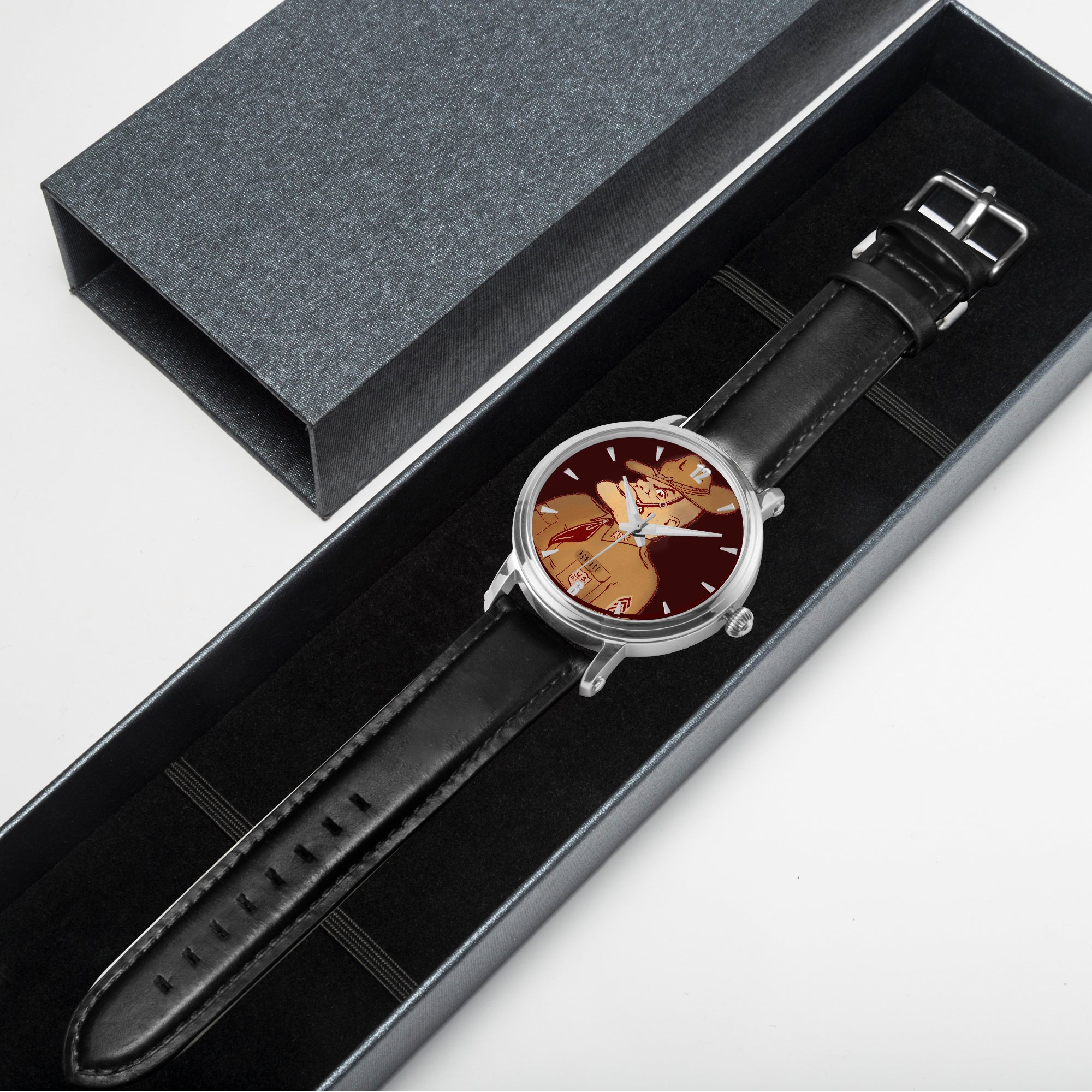 Watch with black leather strap and floral dial in a gray box on a light gray background