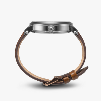 photo showing side of watch with silver face and brown leather band