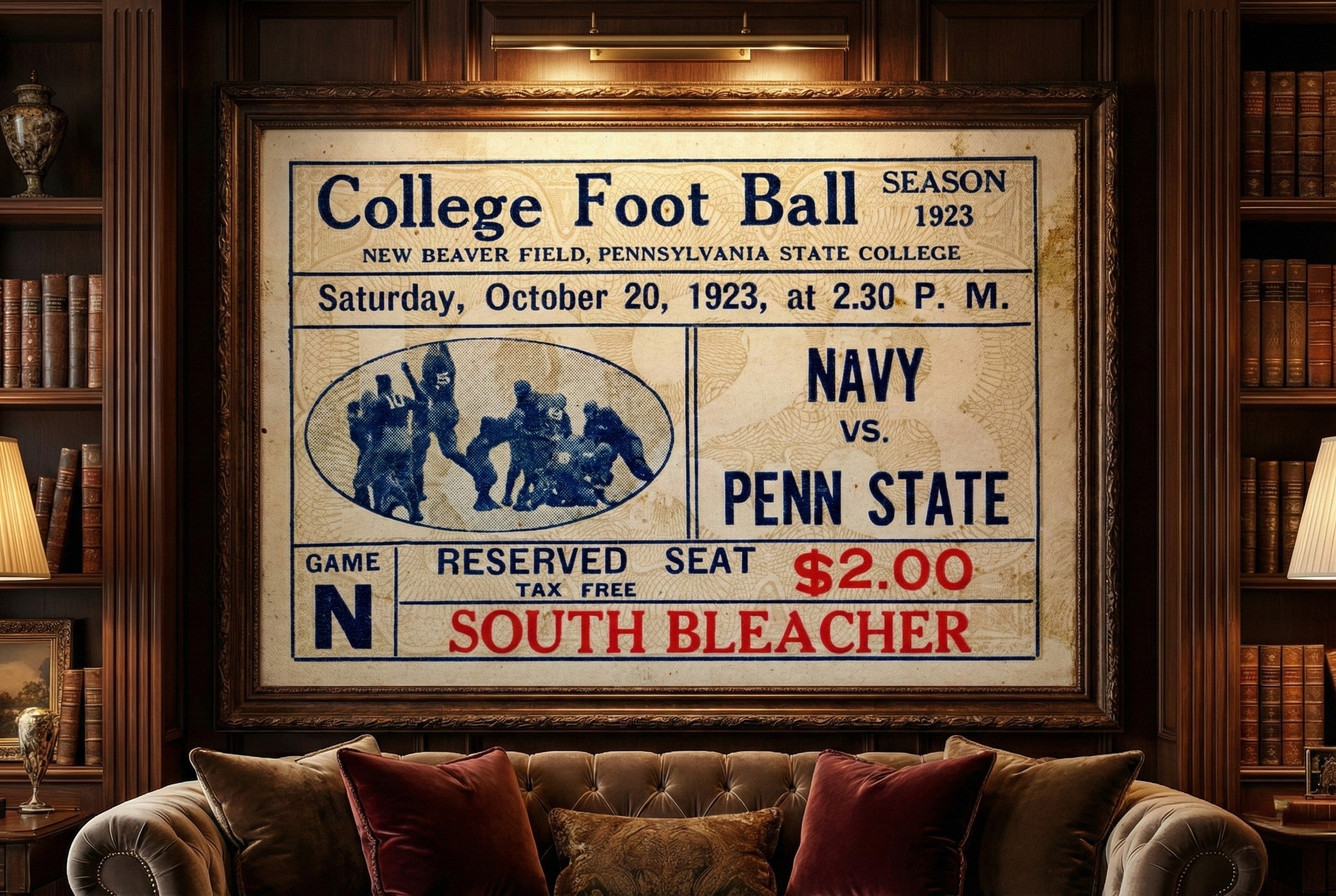 Vintage college football ticket poster framed above a sofa in a room with bookshelves.