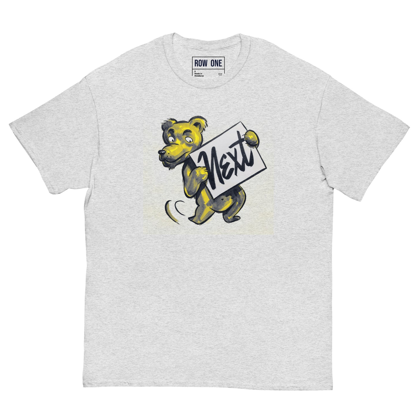 A light heather gray crewneck t-shirt featuring a cartoon graphic of a yellow and navy bear mascot holding a sign that says 'Next'. The brand 'ROW ONE' is printed on the inner neck label.