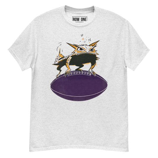 A light heather gray crewneck t-shirt featuring a graphic of a cartoon frog perched on a purple football, with the brand name 'ROW ONE' printed inside the collar.