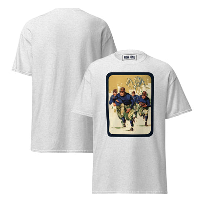 A light heather gray t-shirt shown from both front and back. The front features a large rectangular graphic print depicting four football players in blue and green uniforms on a beige background with a dark border.