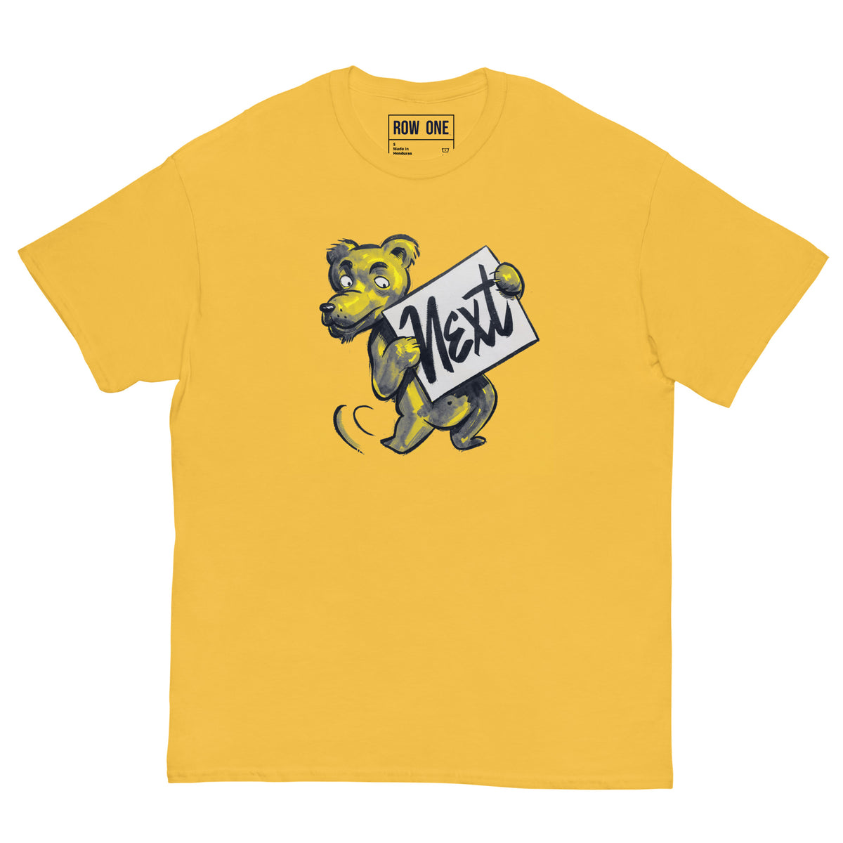 A yellow crewneck t-shirt featuring a cartoon tiger mascot holding a sign that says 'Next' in black script. The brand name 'ROW ONE' is printed inside the collar.