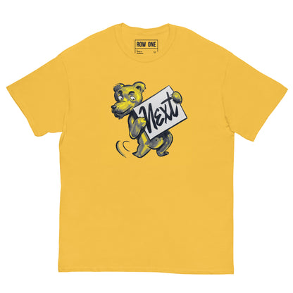 A yellow crewneck t-shirt featuring a cartoon tiger mascot holding a sign that says 'Next' in black script. The brand name 'ROW ONE' is printed inside the collar.