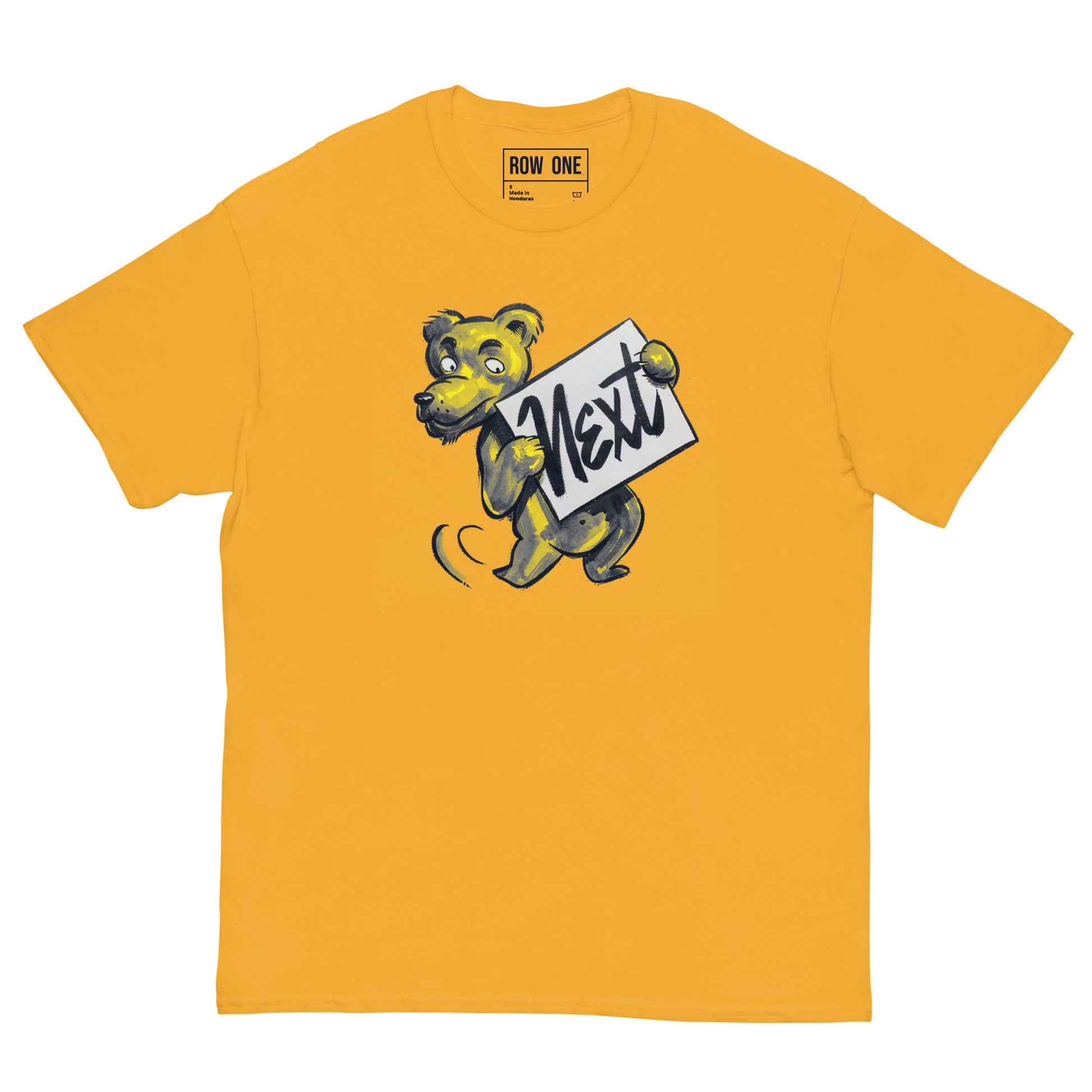 A yellow crewneck t-shirt featuring a cartoon bear mascot holding a sign that reads 'Next' in script. The brand 'ROW ONE' is printed inside the collar.