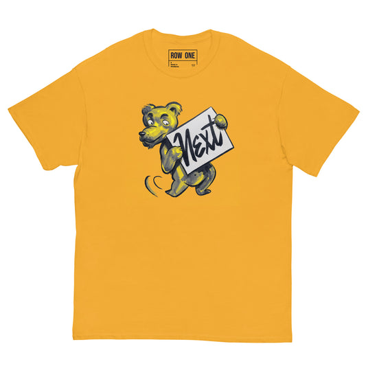 A yellow crewneck t-shirt featuring a cartoon bear mascot holding a sign that reads 'Next' in script. The brand 'ROW ONE' is printed inside the collar.
