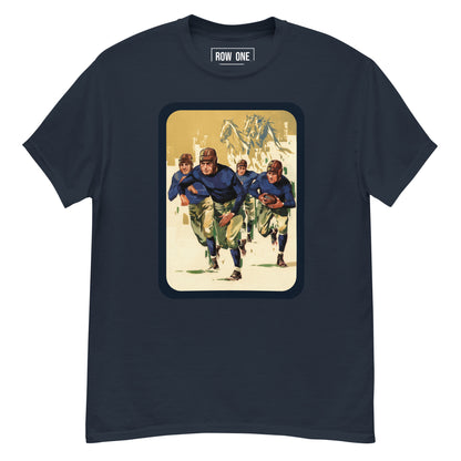 A navy blue crewneck t-shirt featuring a vintage-style graphic print of football players on the front. The graphic has a beige background with a dark blue border and shows players in blue and green uniforms.
