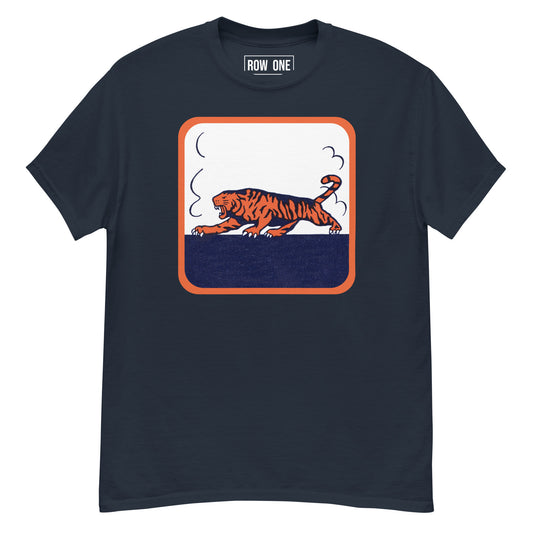 A navy blue crewneck t-shirt featuring a retro-style graphic of a walking tiger in orange and navy, framed by an orange border on a white background. The brand name 'ROW ONE' is printed inside the collar.