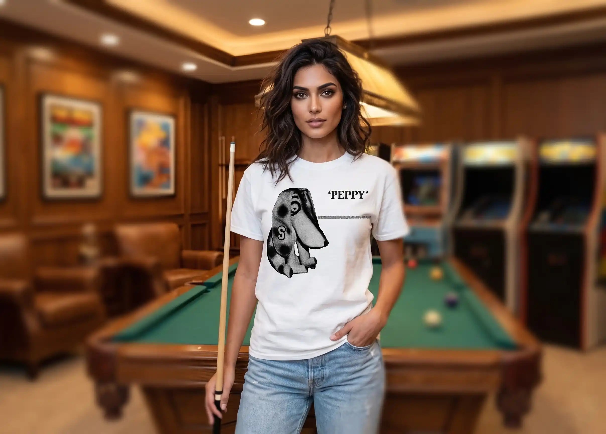 Row One Brand vintage college tee with 1950s Peppy the Dog Graphic Design Worn by Woman in blue jeans in game room with pool table