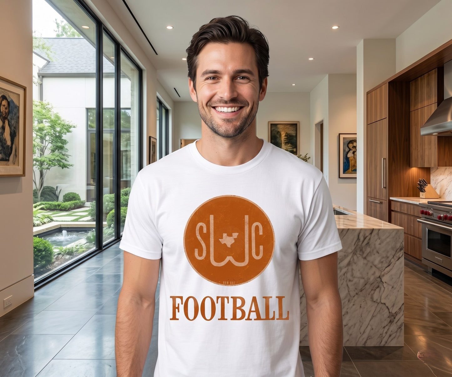Man wearing a white t-shirt with 'SWC Football' design in a modern kitchen.