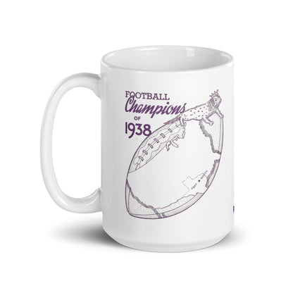 A white ceramic mug with a purple graphic print that reads 'FOOTBALL Champions of 1938' alongside an illustration of a football and a frog head with crown.