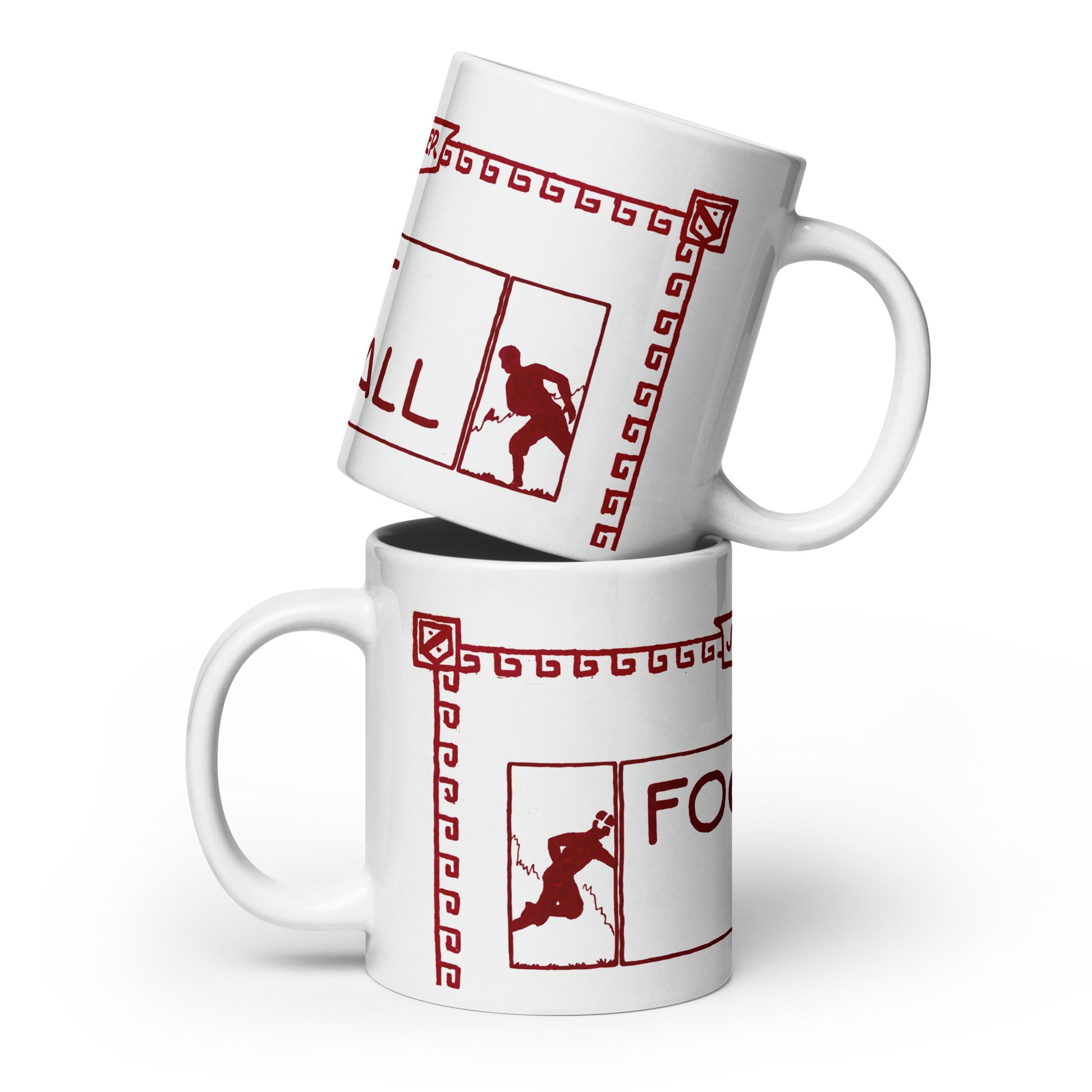 Two white ceramic mugs stacked with a red graphic print featuring a football player silhouette, Greek key border, and partial text on a white background.